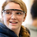 An inspired Trinity college student wearing safety goggles
